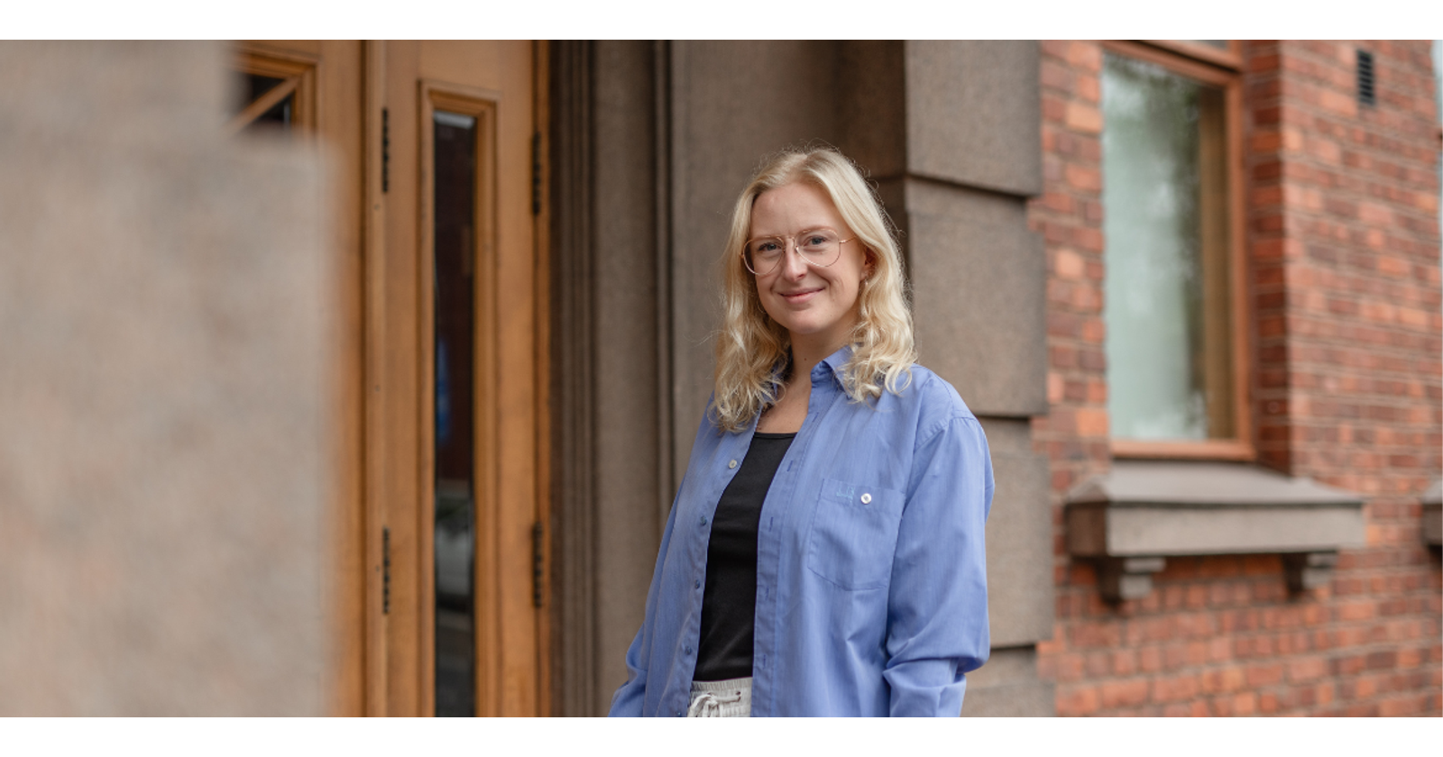 Vappu Vuori in front of Konttori building on campus.